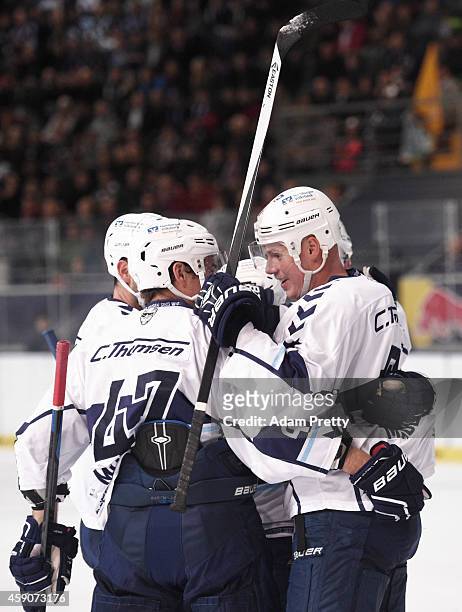 Morten Madsen of the Freezers is congratulated by team mates after scoring the first goal during the DEL Ice Hockey match between EHC Red Bull...