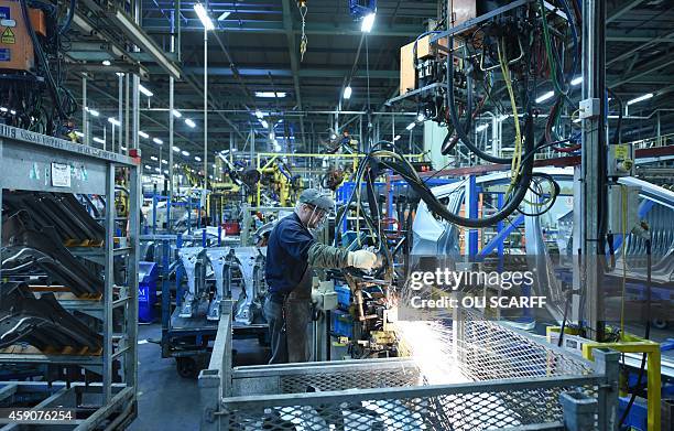 Member of Nissan's manufacturing staff welds vehicle panels in the Body Shop in their Sunderland Plant in Sunderland, North East England on November...