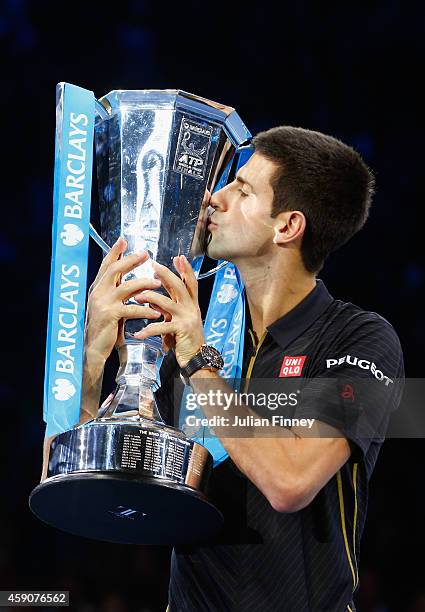 Novak Djokovic of Serbia poses with the ATP trophy on day eight of the Barclays ATP World Tour Finals at O2 Arena on November 16, 2014 in London,...