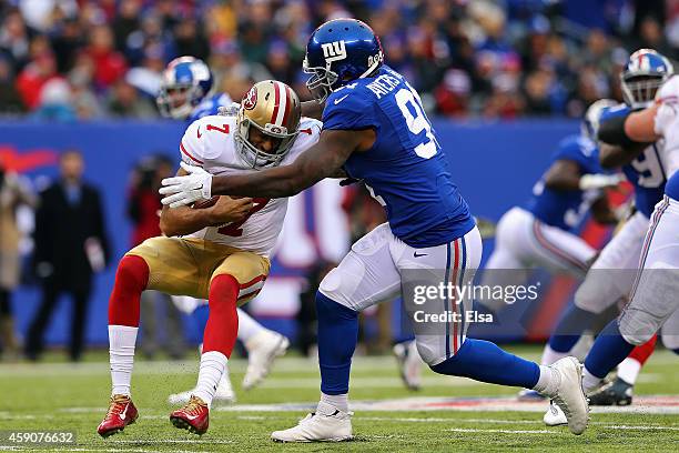 Robert Ayers of the New York Giants sacks Colin Kaepernick of the San Francisco 49ers in the first quarter at MetLife Stadium on November 16, 2014 in...
