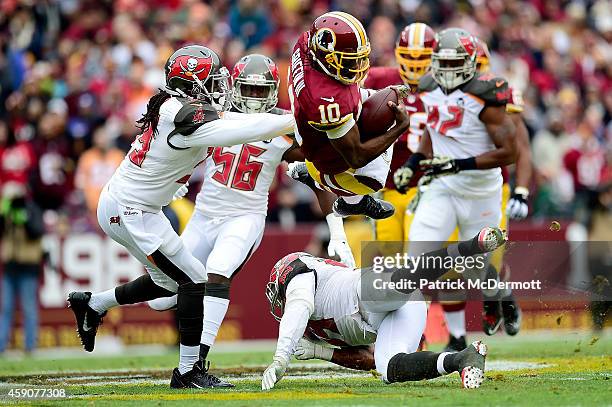 Quarterback Robert Griffin III of the Washington Redskins takes a second quarter hit from defensive back Brandon Dixon of the Tampa Bay Buccaneers at...