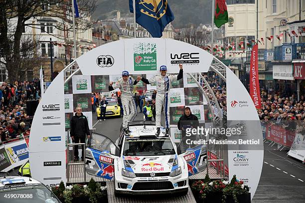 Sebastien Ogier of France and Julien Ingrassia of France celebrate their victory in the final podium during Day Three of the WRC Great Britain on...