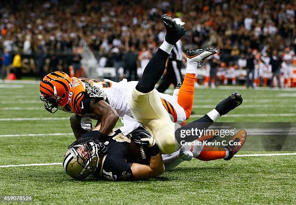 Rey Maualuga of the Cincinnati Bengals and Shawn Williams of the Cincinnati Bengals stop a fourth down conversion by Erik Lorig of the New Orleans...