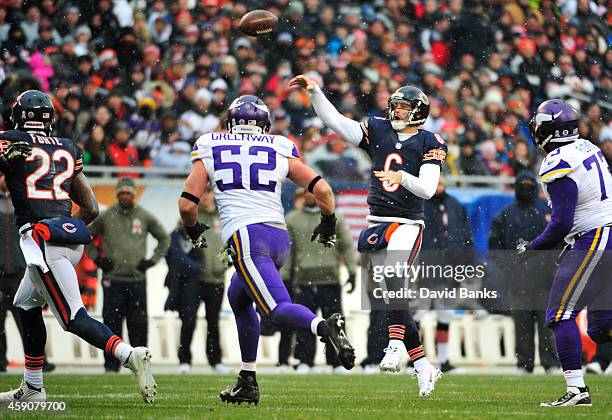 Jay Cutler of the Chicago Bears passes as Chad Greenway of the Minnesota Vikings and Sharrif Floyd defend during the second quarter of a game at...