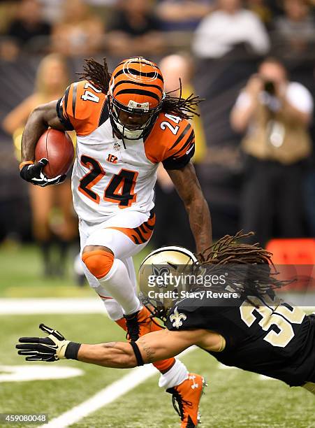Adam Jones of the Cincinnati Bengals catches the ball as Marcus Ball of the New Orleans Saints defends during the second half at Mercedes-Benz...