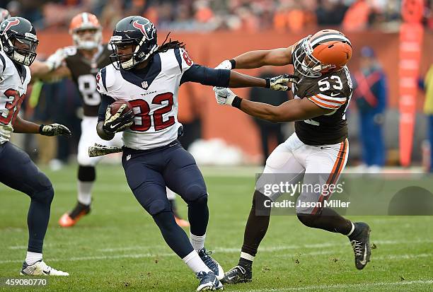 Keshawn Martin of the Houston Texans breaks a tackle by Craig Robertson of the Cleveland Browns during the third quarter at FirstEnergy Stadium on...