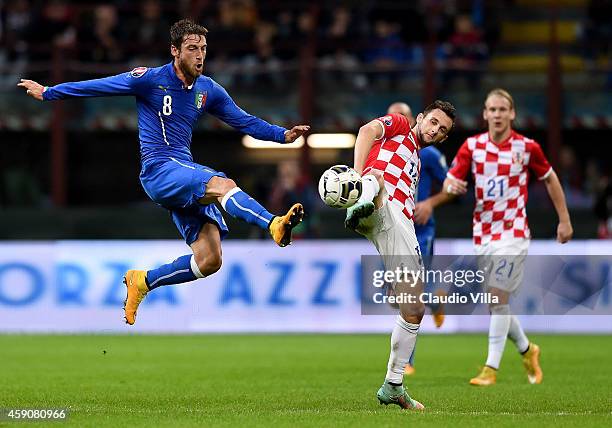 Claudio Marchisio of Italy and Marcelo Brozovic of Croatia compete for the ball during the EURO 2016 Group H Qualifier match between Italy and...
