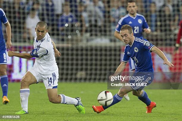 Israel's midfielder Gil Vermouth vies for the ball with Bosnia-Herzegovina's midfielder Edin Visca during a UEFA 2016 European Championship...