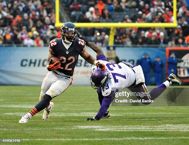 Matt Forte of the Chicago Bears runs past Sharrif Floyd of the Minnesota Vikings during the third quarter on November 16, 2014 at Soldier Field in...