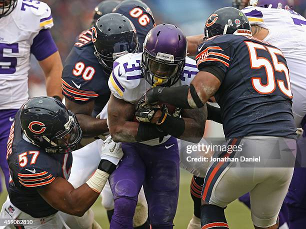 Jerick McKinnon of the Minnesota Vikings is stopped by Jon Bostic, Jeremiah Ratliff and Lance Briggs of the Chicago Bears at Soldier Field on October...