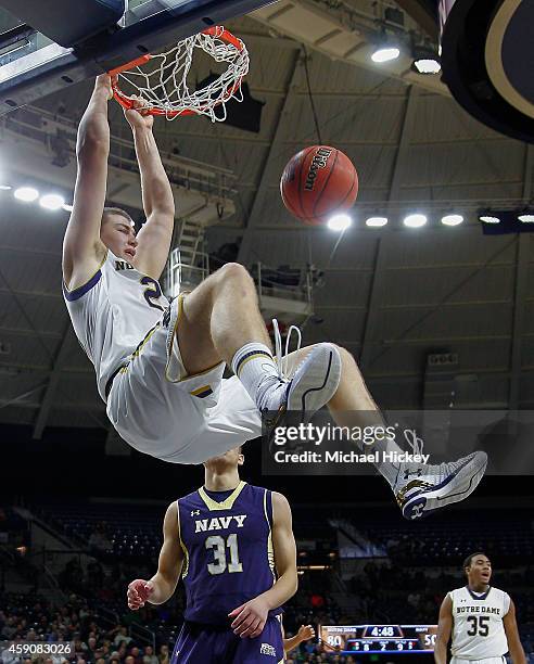 Martinas Geben of the Notre Dame Fighting Irish dunks the ball as Tom Lacey of the Navy Midshipmen looks on at Purcell Pavilion on November 16, 2014...