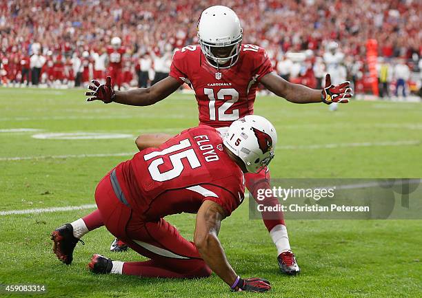 Wide receiver Michael Floyd of the Arizona Cardinals is congratulated by wide receiver John Brown after scoring a 42 yard touchdown reception in the...