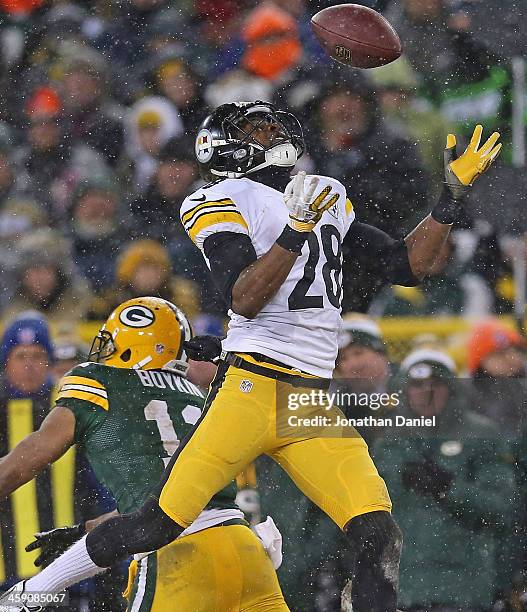 Cortez Allen of the Pittsburgh Steelers intercepts a pass for a touchdown against the Green Bay Packers at Lambeau Field on December 22, 2013 in...