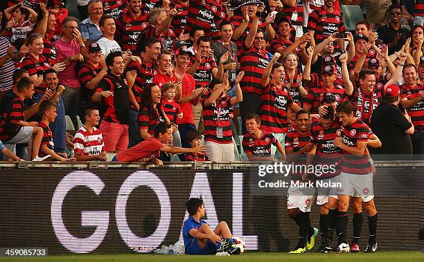 Tomi Juric of the Wanderers celebrates with team mates after scoring during the round 11 A-League match between the Western Sydney Wanderers and the...