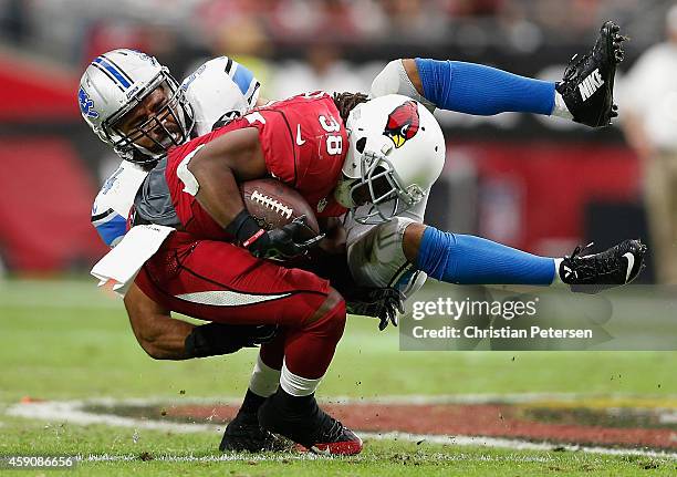 Running back Andre Ellington of the Arizona Cardinals is tackled by outside linebacker DeAndre Levy of the Detroit Lions in the first quarter during...