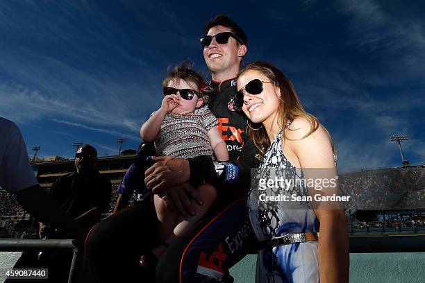 Denny Hamlin, driver of the FedEx Express Toyota, stands on the grid with his girlfriend, Jordan Fish, and his daughter, Taylor James Hamlin during...