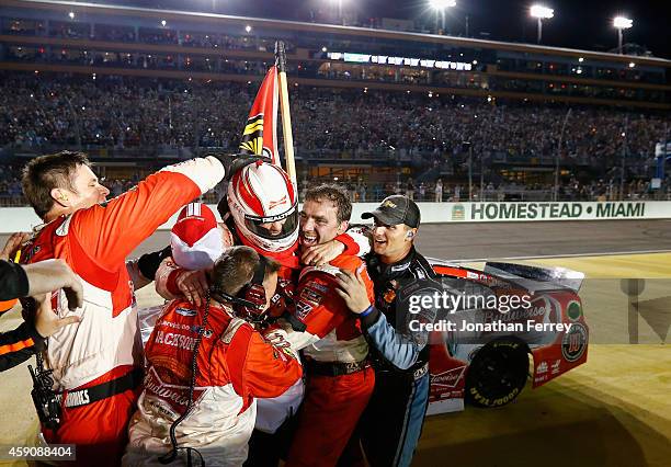 Kevin Harvick, driver of the Budweiser Chevrolet, celebrates winning with his team after the NASCAR Sprint Cup Series Ford EcoBoost 400 at...