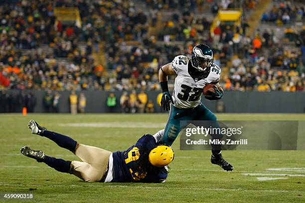 Josh Boyd of the Green Bay Packers attempts to tackle Chris Polk of the Philadelphia Eagles during the fourth quarter of the game at Lambeau Field on...