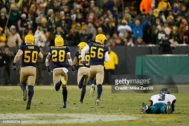 Casey Hayward of the Green Bay Packers runs a fumble by quarterback Mark Sanchez of the Philadelphia Eagles for a touchdown during the fourth quarter...