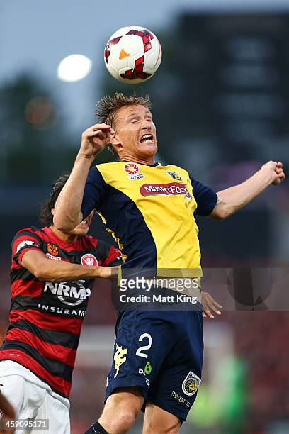 Daniel McBreen of the Mariners heads the ball in front of Jerome Polenz of the Wanderers during the round 11 A-League match between the Western...