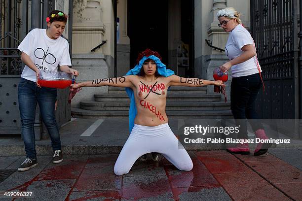 Members of the FEMEN activist group protest outside San Manuel y San Benito church in Madrid against the Spanish Government plan to cut women's right...