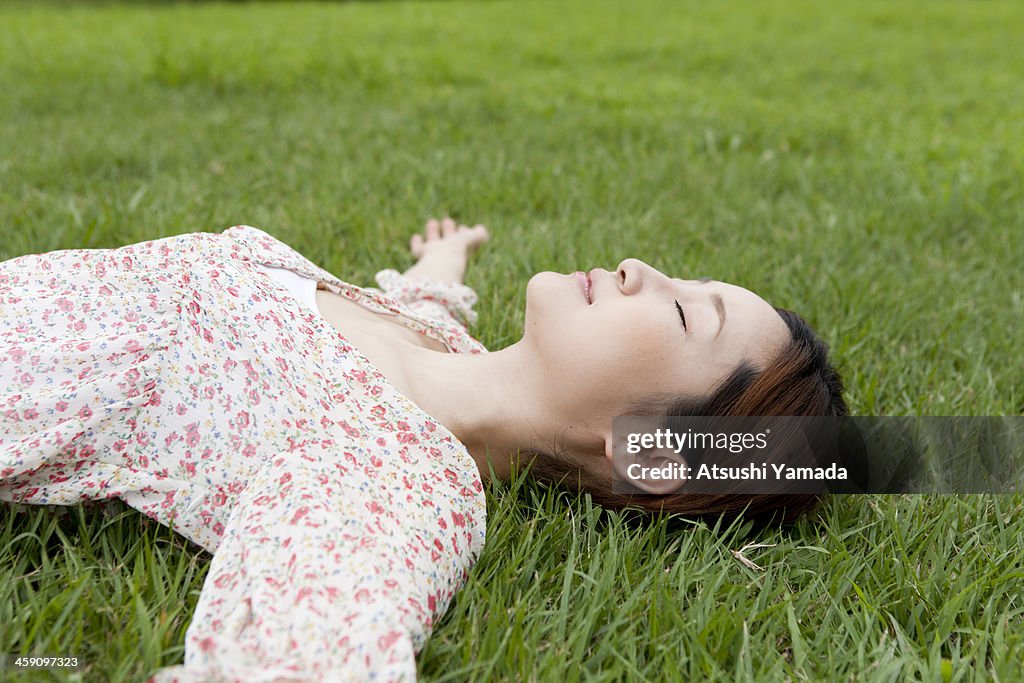 Woman  sleeping on grass