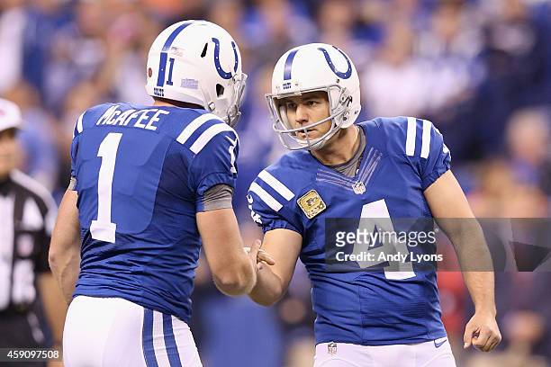 Adam Vinatieri of the Indianapolis Colts celebrates a field goal with Pat McAfee of the Indianapolis Colts against the New England Patriots during...