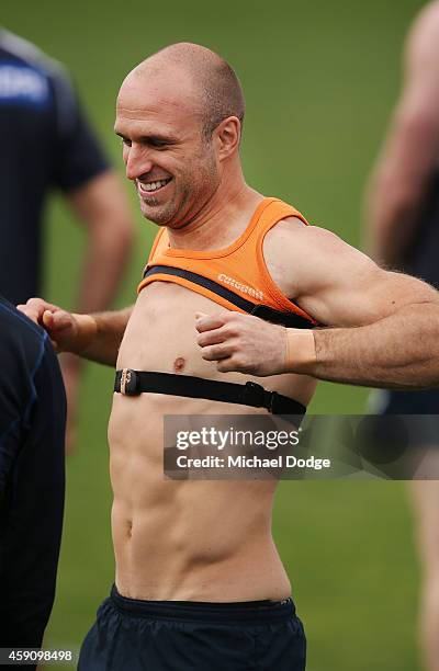Chris Judd of the Blues puts on a singlet during a Carlton Blues AFL pre-season training session at Visy Park on November 17, 2014 in Melbourne,...
