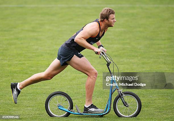 Lachie Henderson of the Blues rides a scooter during a Carlton Blues AFL pre-season training session at Visy Park on November 17, 2014 in Melbourne,...