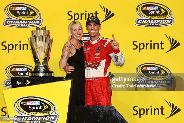 Kevin Harvick, driver of the Budweiser Chevrolet, celebrates with his wife DeLana in Victory Lane after winning the NASCAR Sprint Cup Series Ford...