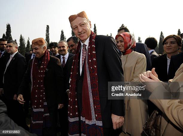 Turkish Prime Minister Recep Tayyip Erdogan visits the Grand Cultural Show as he wears a traditional cap that was given as a present by the Chief...