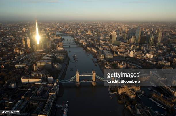Tower Bridge spans the River Thames as skyscrapers including the Shard, Tower 42, the Heron Tower, the Leadenhall building, also known as the...
