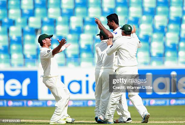 Ehsan Adil of Pakistan is congratulated by team mates after taking the wicket of Brendon McCullum, New Zealand Captain during day one of the second...