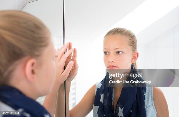 Portrait of a twelve-year-old girl in front of a mirror on August 12 in Duelmen, Germany. Photo by Ute Grabowsky/Photothek via Getty Images)