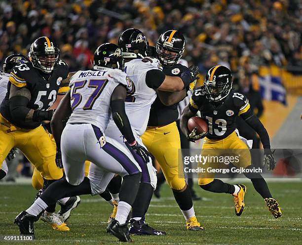 Running back Dri Archer of the Pittsburgh Steelers runs with the football as offensive linemen Maurkice Pouncey and Ramon Foster block linebacker...