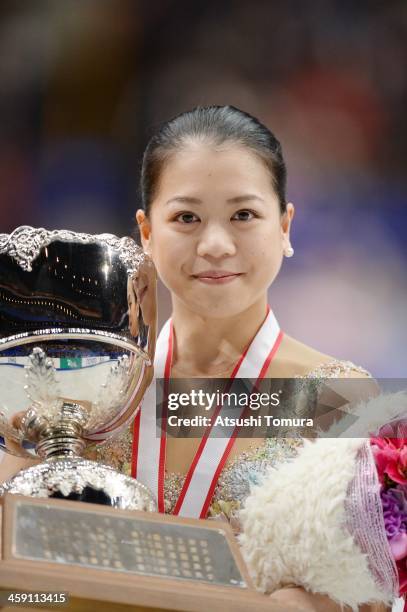 Akiko Suzuki of Japan poses in the victory ceremony during All Japan Figure Skating Championships at Saitama Super Arena on December 23, 2013 in...