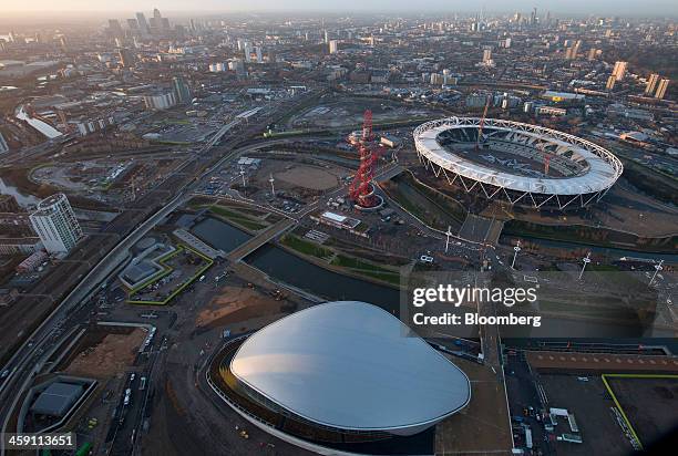 The Aquatics center, left, and the London 2012 Olympic Stadium, right, are seen in this aerial photograph looking towards the Canary Wharf business...