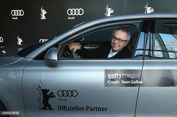 Dieter Kosslick, Director of the Berlinale International Film Festival, poses while sitting in the driver's seat of an Audi limousine at Audi City...