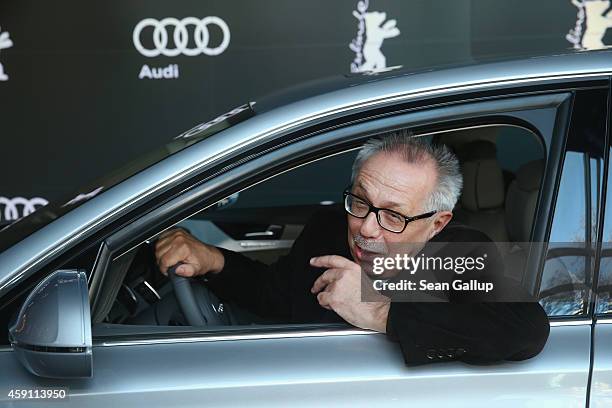 Dieter Kosslick, Director of the Berlinale International Film Festival, poses while sitting in the driver's seat of an Audi limousine at Audi City...