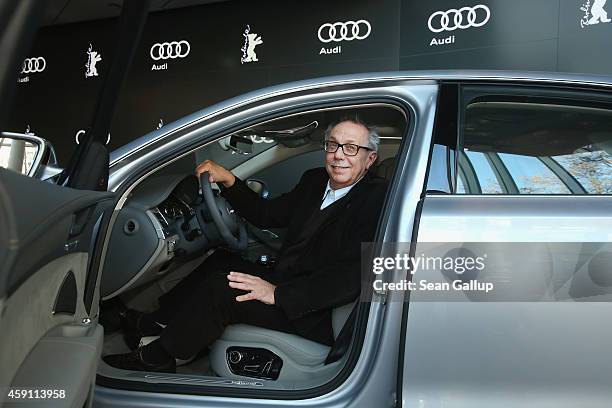 Dieter Kosslick, Director of the Berlinale International Film Festival, poses while sitting in the driver's seat of an Audi limousine at Audi City...