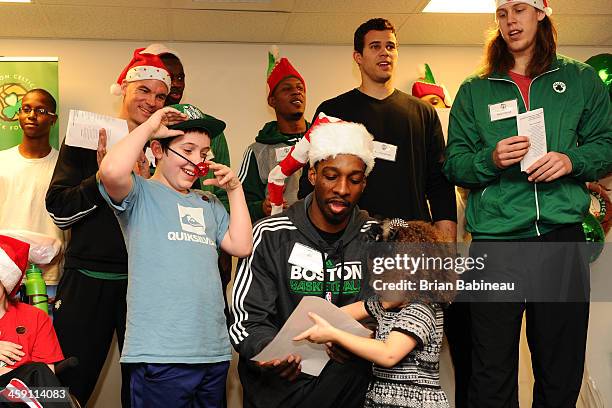 Jeff Green, Kelly Olynyk, Brandon Bass, Keith Bogans and Kris Humphries of the Boston Celtics visit patients and sing Christmas songs on December 19,...