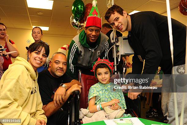 Keith Bogans and Kris Humphries of the Boston Celtics visits patients and spreads holiday cheer on December 19, 2013 at Children's Hospital in...