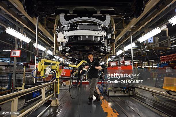 Member of Nissan's manufacturing staff works in the 'Trim and Chassis' section of their Sunderland Plant in Sunderland, North East England on...