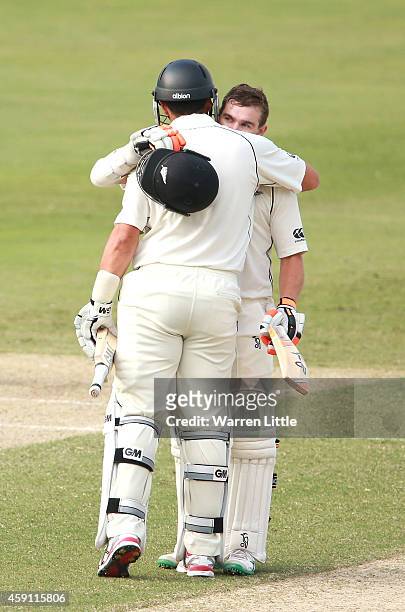 Tom Latham of New Zealand is congratulated by team mate Ross Taylor after reaching his century during day one of the second test between Pakistan and...