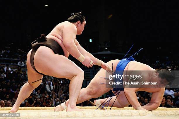 Mongolian yokozuna Hakuho throws Ichinojo to win during day nine of the Grand Sumo Kyushu Tournament at Fukuoka Convention Center on November 17,...