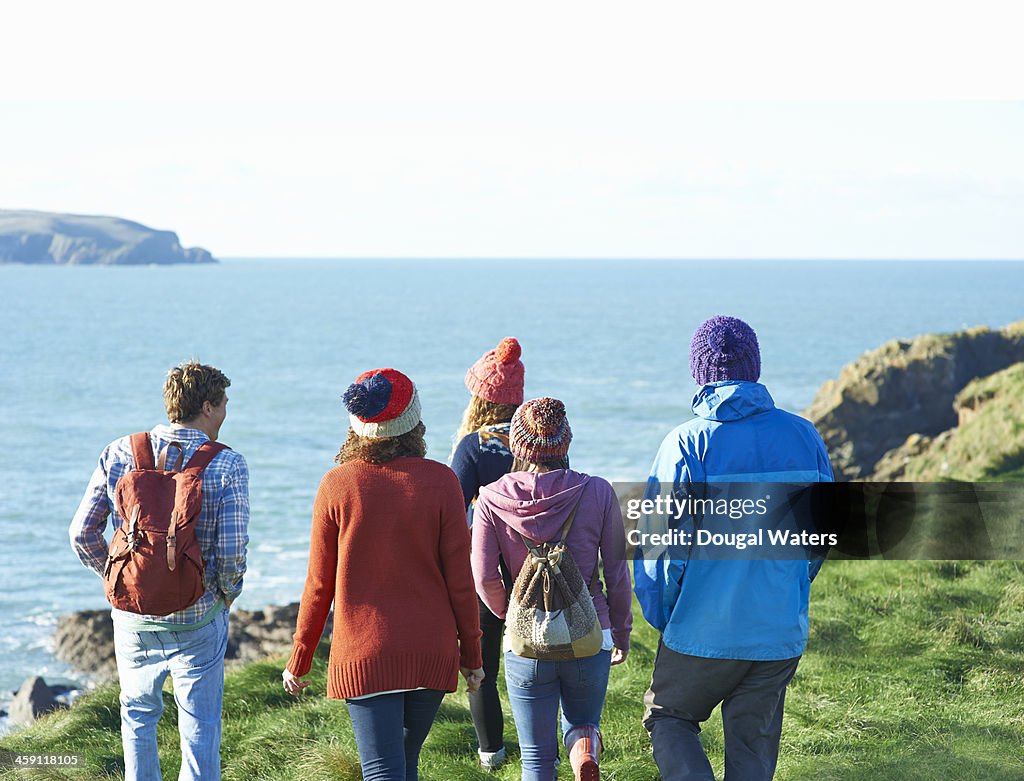 Group walking along Atlantic coastline.