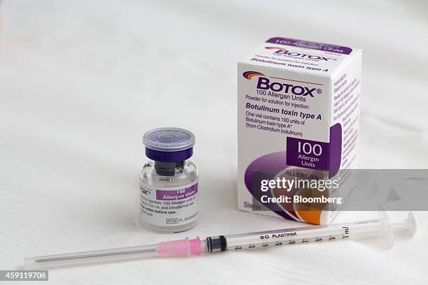 Syringe rests alongside a vial of Allergan Botox, produced by Allergan Inc., in this arranged photograph taken at a skin and beauty clinic in London,...