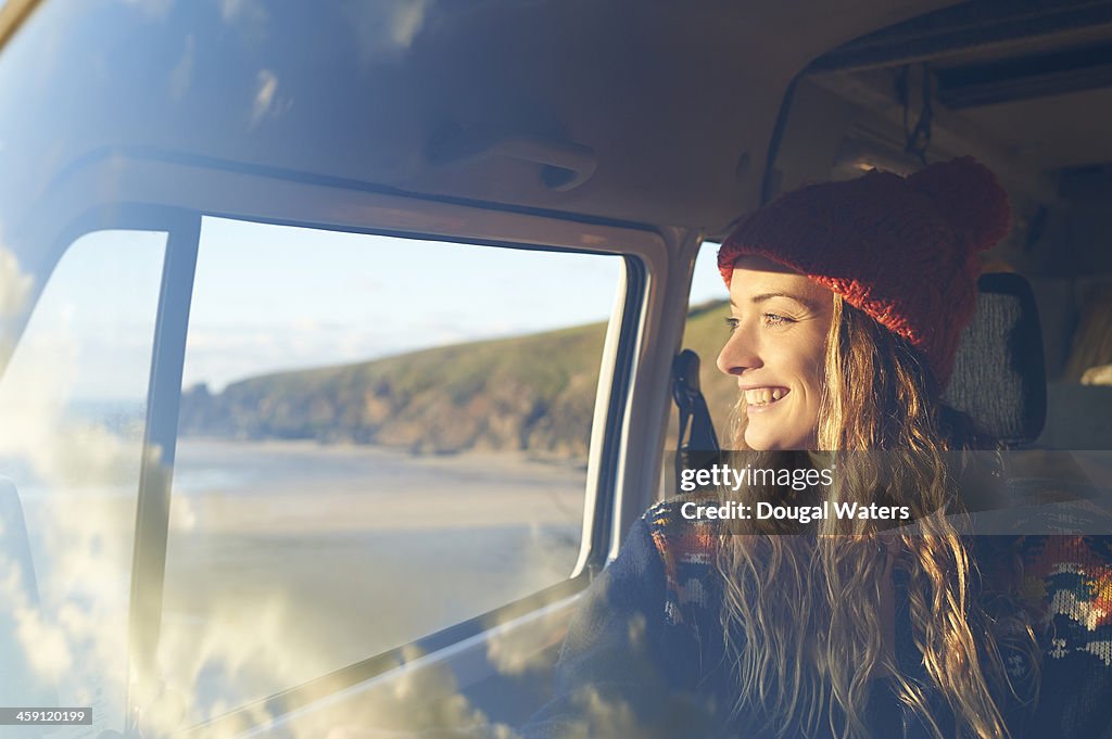 Woman looking out of camper van window.