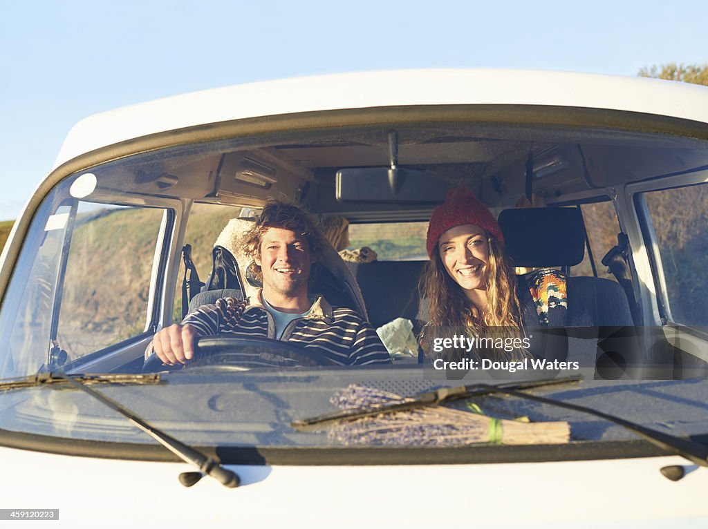 Couple siting in camper van.