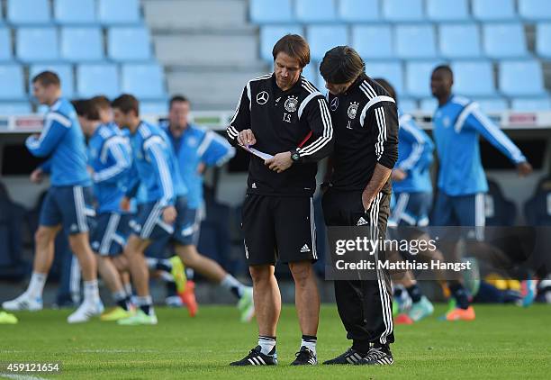 Head coch Joachim Loew of Germany discusses with assistant coach Thomas Schneider of Germany during a training session ahead of their International...